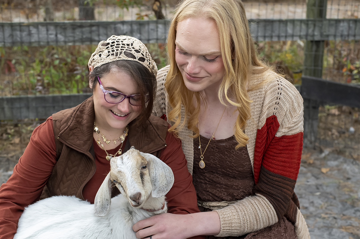 same sex engaged couple at farm for fall engagement photos