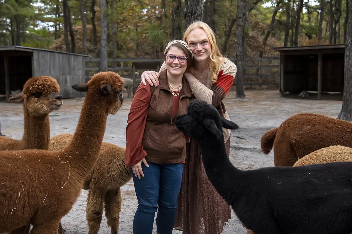 same sex engaged couple at alpaca farm for fall engagement photos