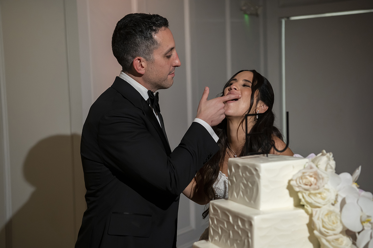 bride and groom cake cutting on their wedding day at Hudson House
