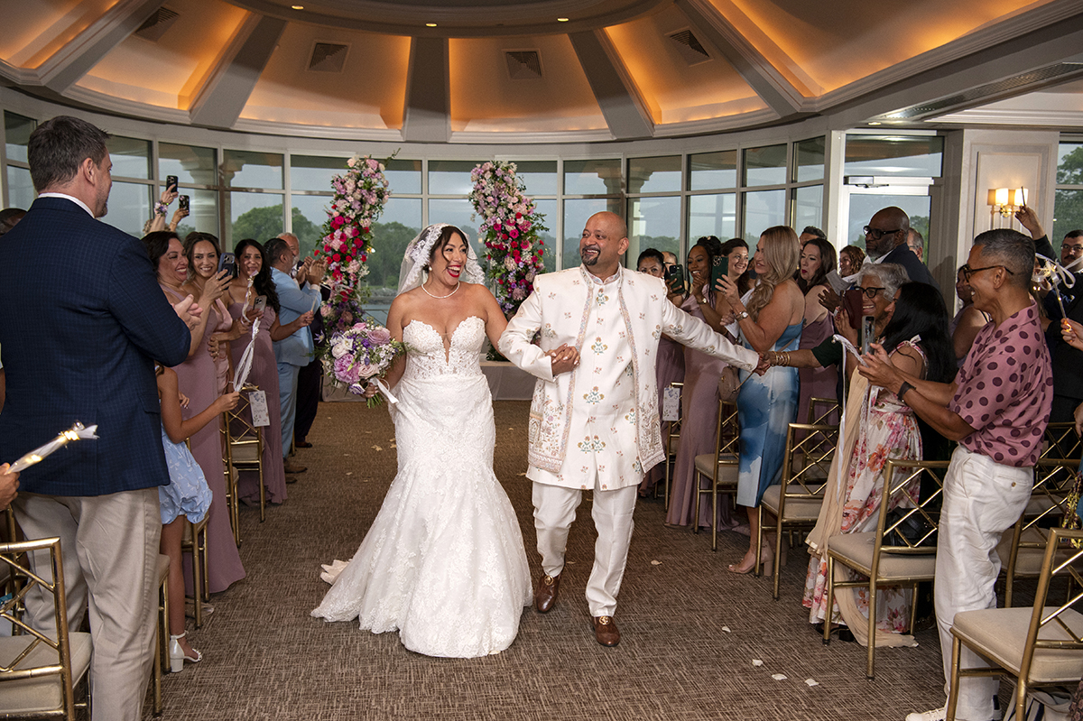 bride and groom walking after their wedding ceremony at their Glen Island Harbour Club wedding